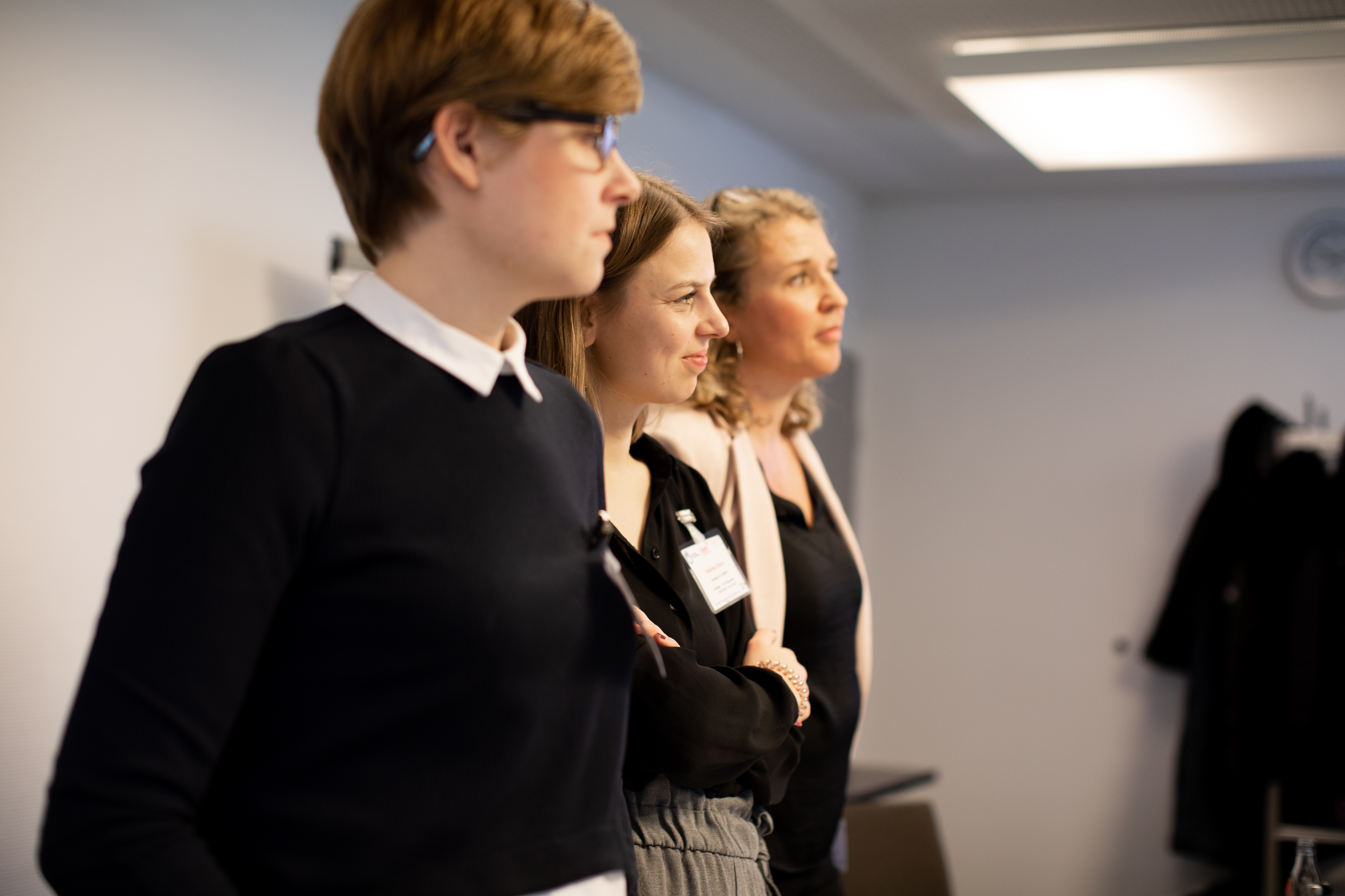 The photo shows three members of the project