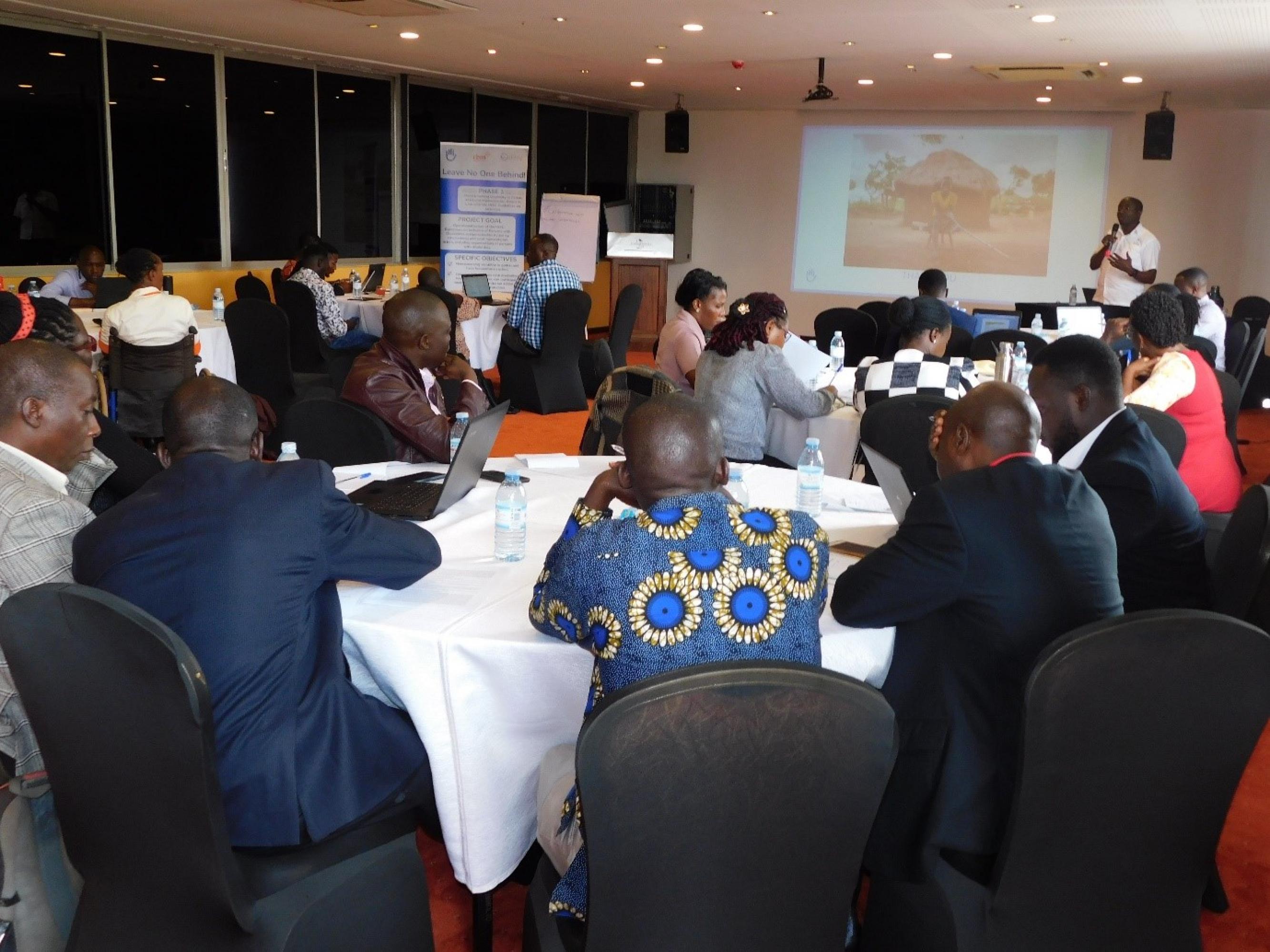 Photo of the project national level kick-off workshop. Participants listening a presentation.