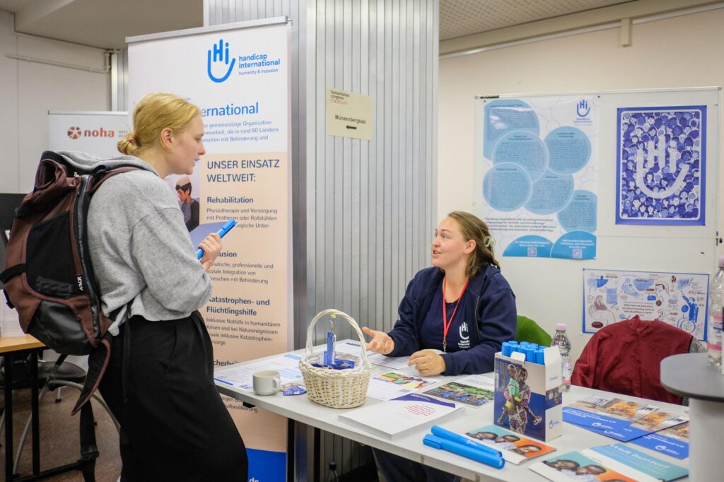 Conference participant visiting HI booth during the HCB 2023.