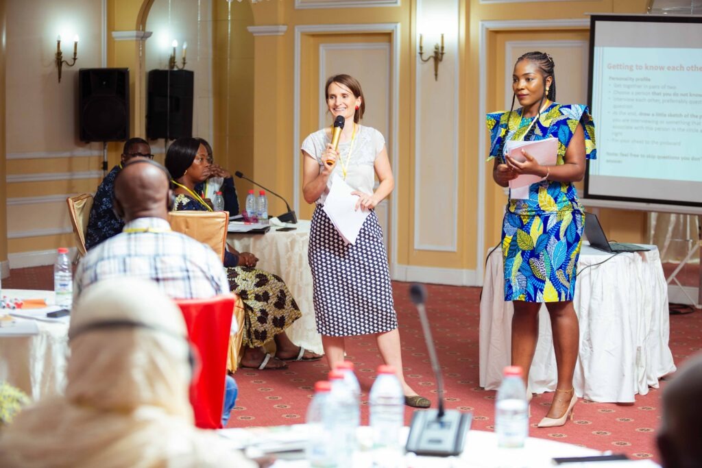 Two training moderators speaking in front of the participants.