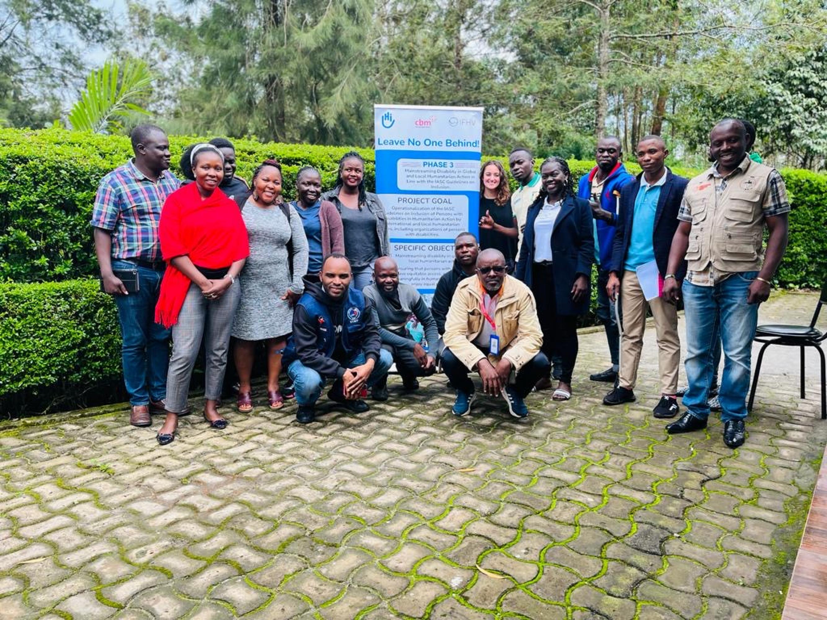 Group photo of the workshop participants posing outside of the training venue in Uganda.