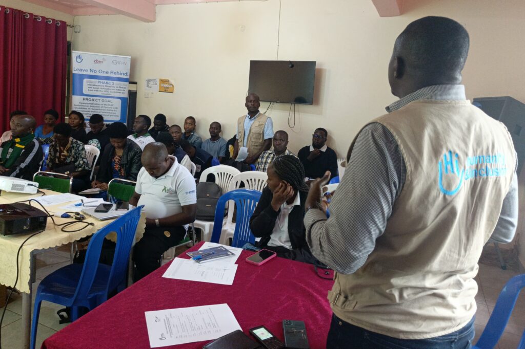 Man speaking in front of the workshop participants.