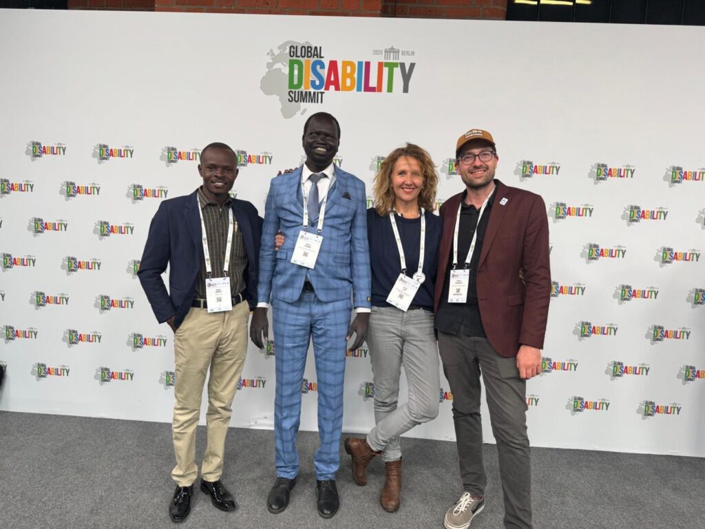 Four project staff members standing and posing for the camera