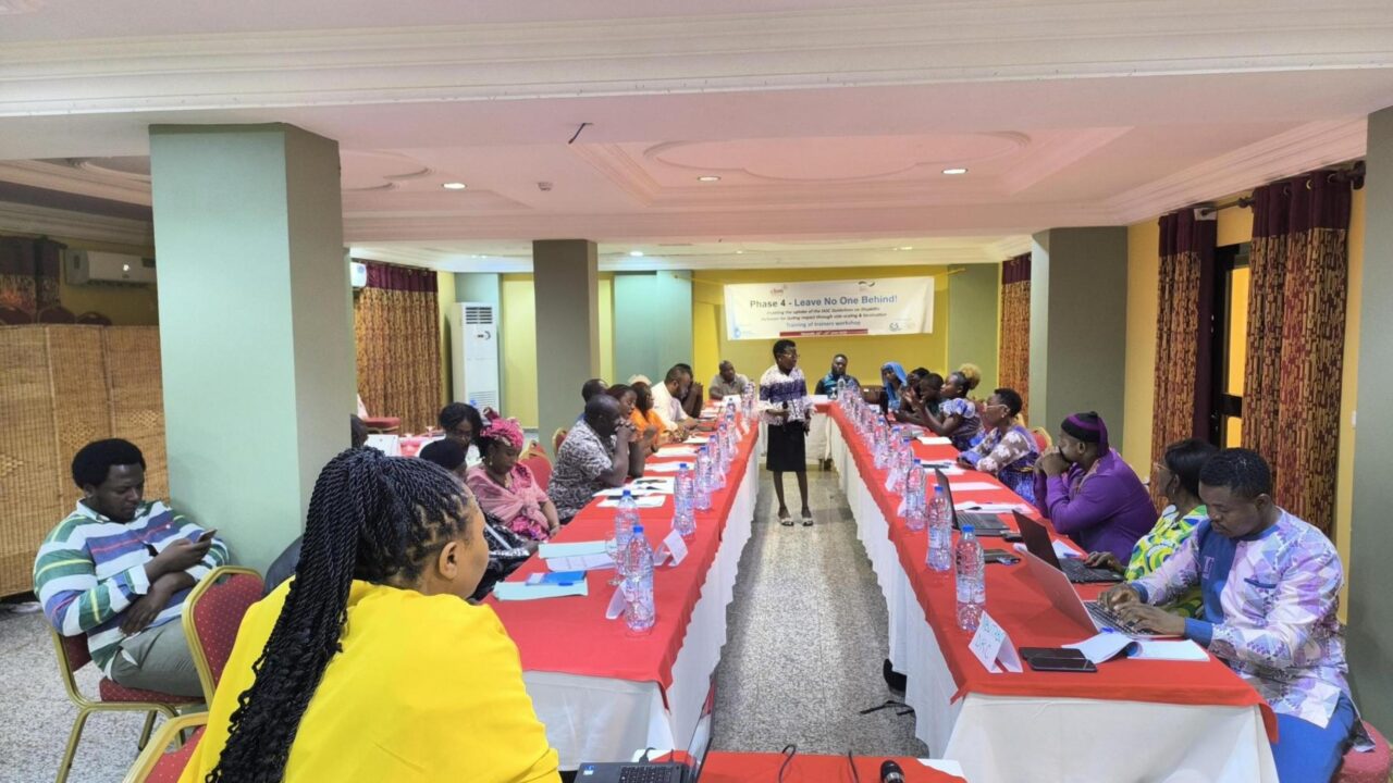 Barbara Achwe stands at the front of a conference room, welcoming and introducing participants to the ToT Training in Yaoundé. © CBM