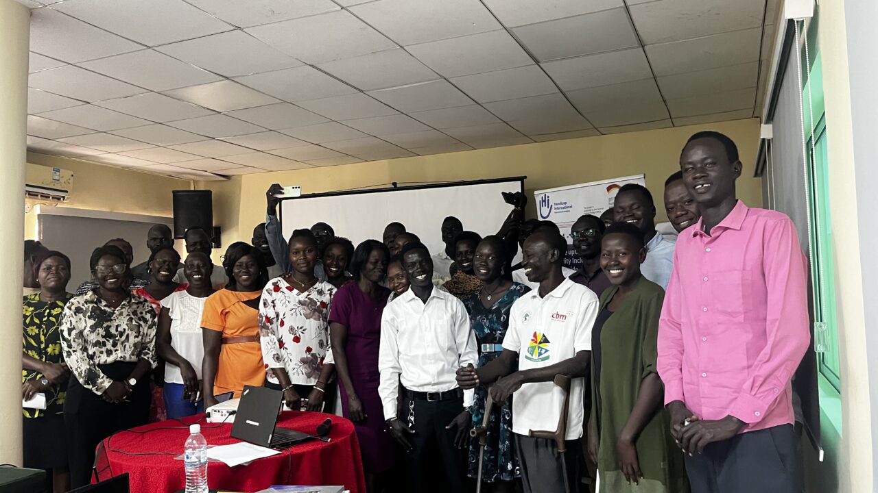 Participants pose for a group photo during the inclusive WASH RAAL-lab training at Regency Hotel- Juba, South Sudan © Seppora/ HI, South Sudan.