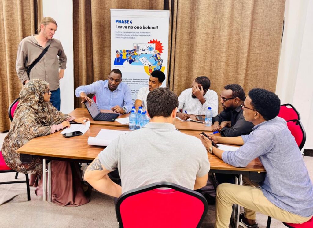 Participants' group work pose during HNRP Workshop in Peace Hotel, Mogadishu, Somalia 