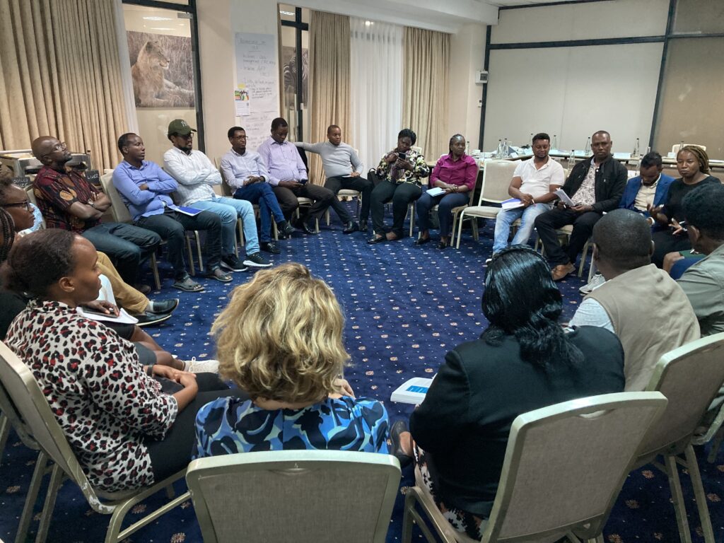 Training participants sitting in a circle during final feedback round.
