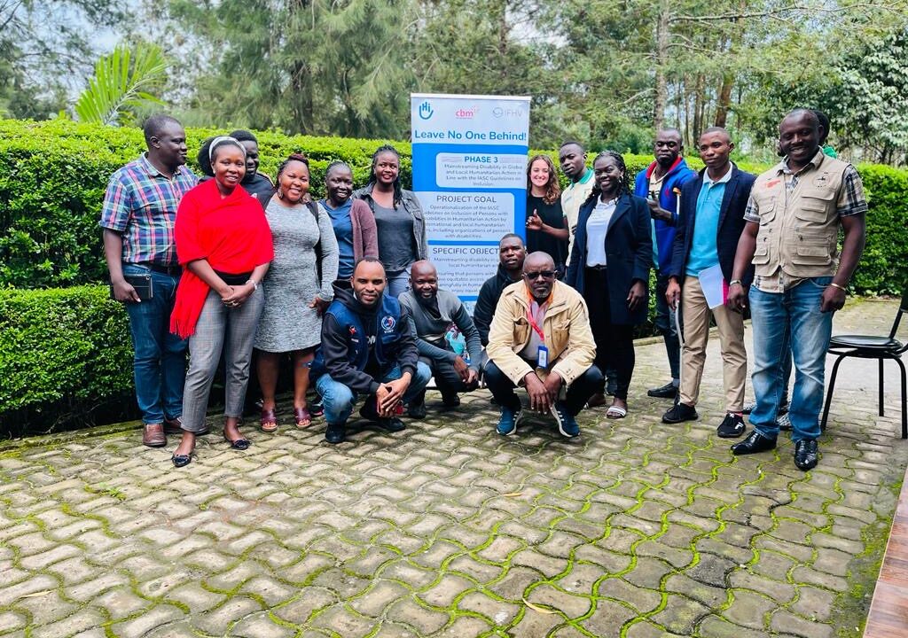 Group photo of the workshop participants posing outside of the training venue in Uganda.