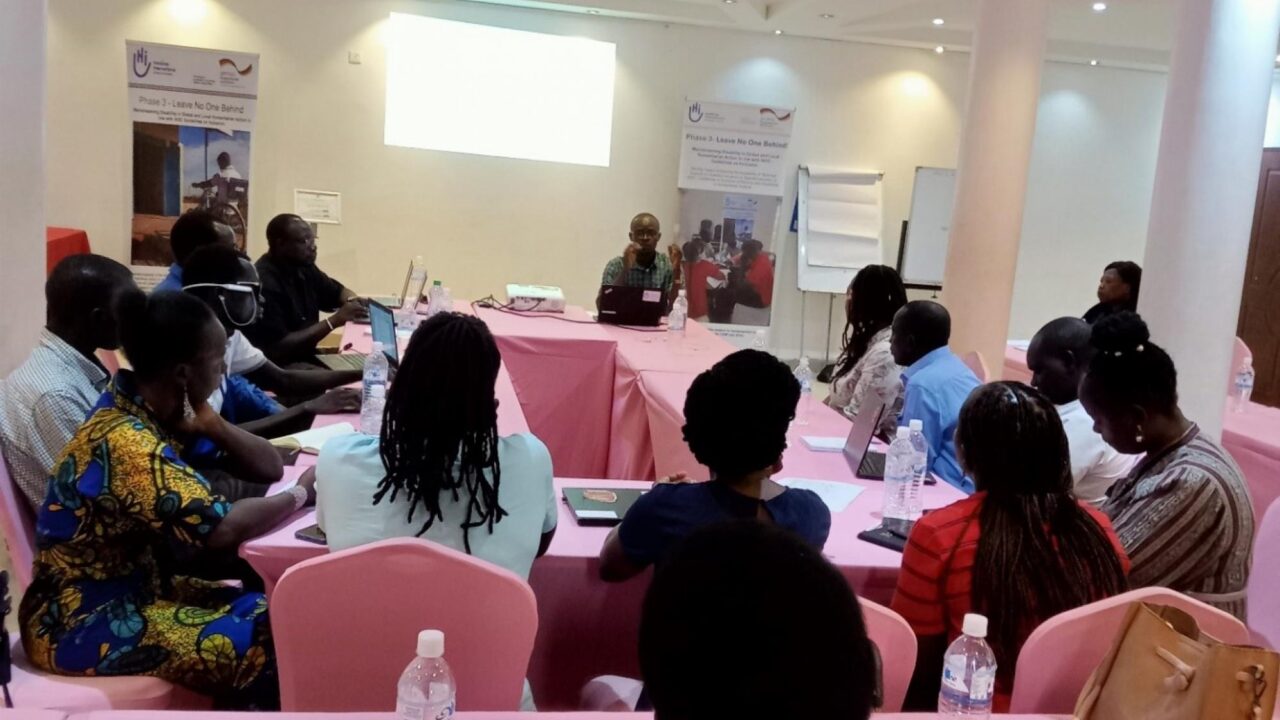 Group of persons sitting in a meeting room and listening a presentation.