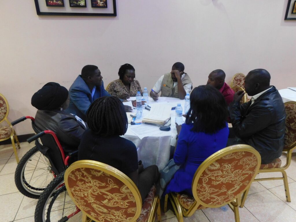 Group of workshop participant sitting around a round table and discussing.