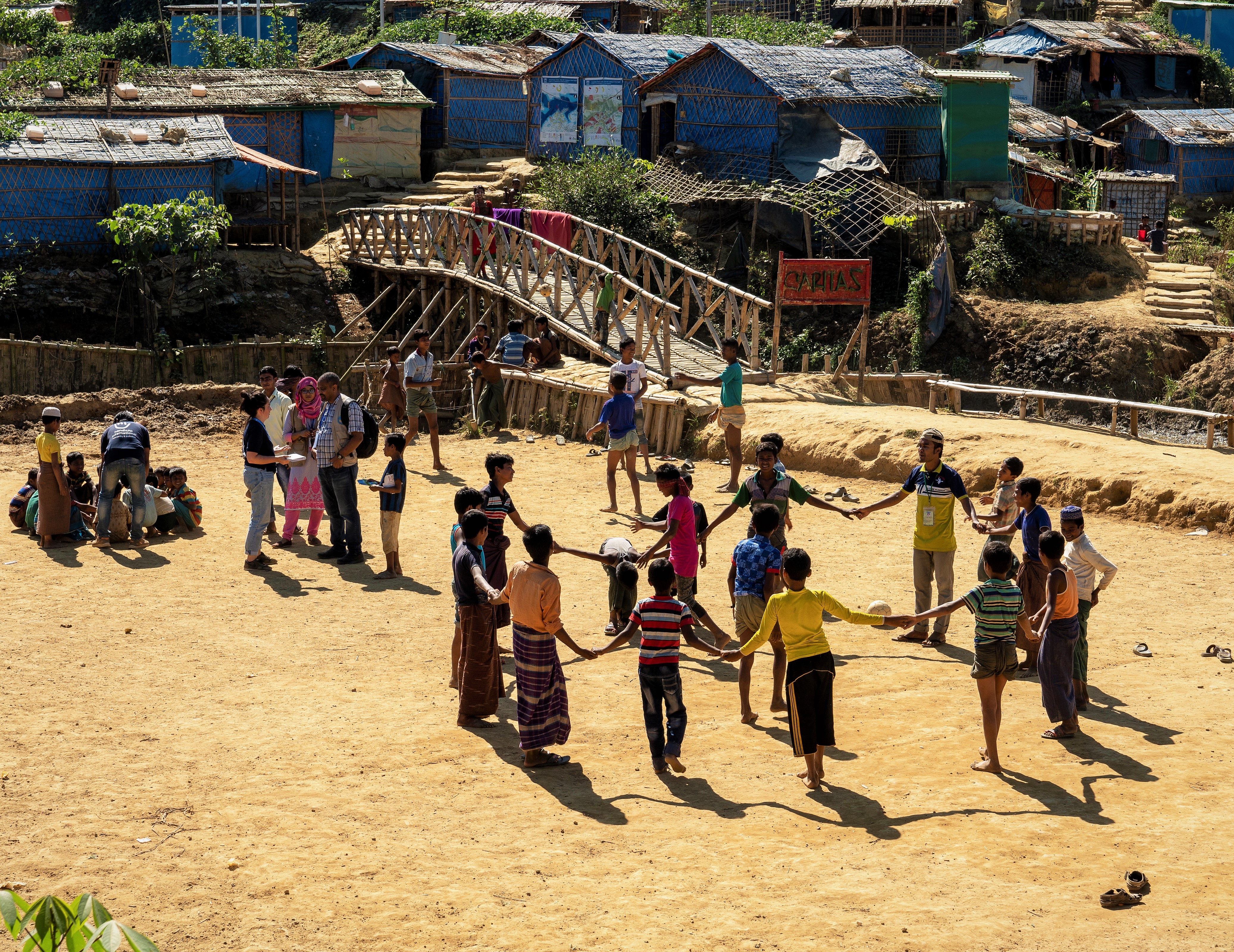 A group of children with and without disabilities playing games in a refugee camp in Ukhiya. 